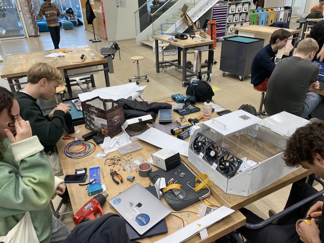 Asclepios Lab students building hardware around a workbench